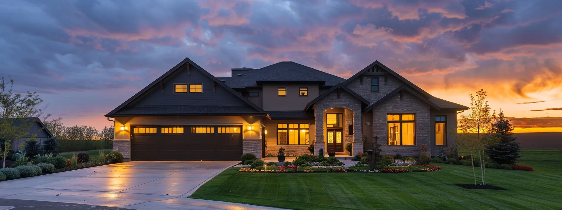 a modern suburban home at dusk, illuminated by warm exterior lighting, showcases a well-manicured lawn and a two-car garage against a slightly cloudy sky, emphasizing the importance of reliable backup power solutions in a peaceful neighborhood.