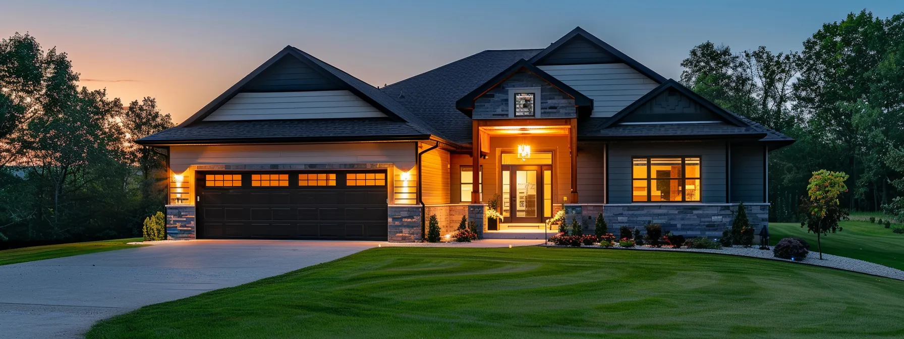 a modern suburban home stands peacefully at dusk, illuminated by warm exterior lighting, with a neatly maintained lawn and a two-car garage, subtly foreshadowing an impending storm that emphasizes the importance of having a reliable emergency generator.